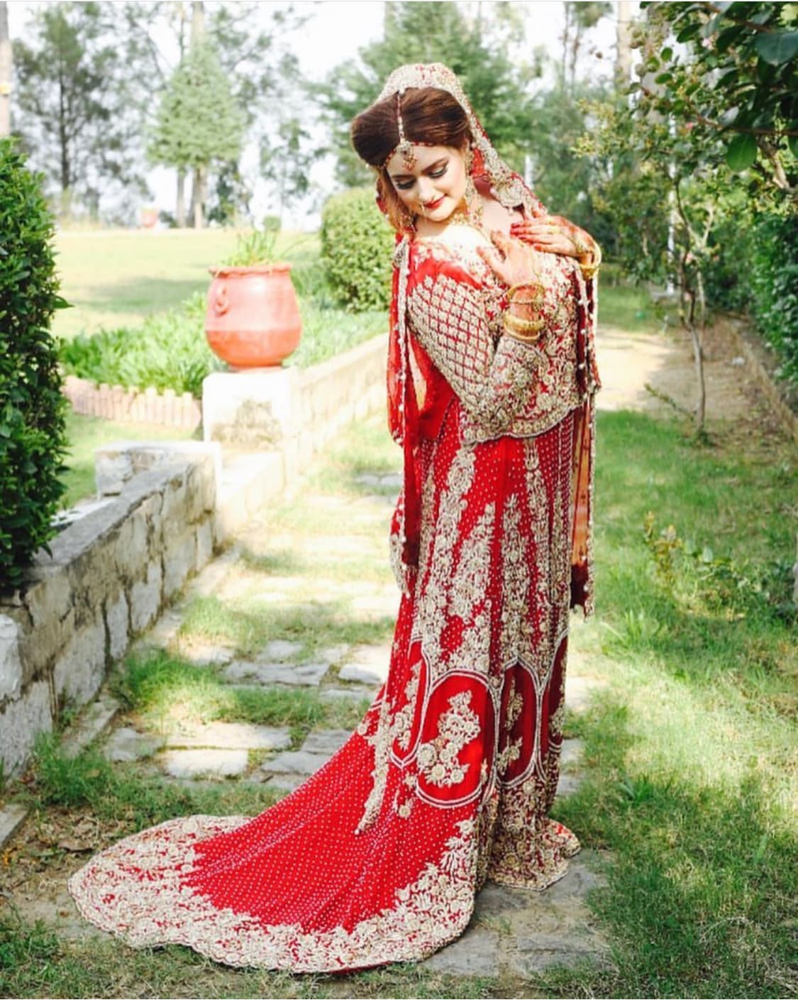 Nikkah day glam in red and gold, garden portrait